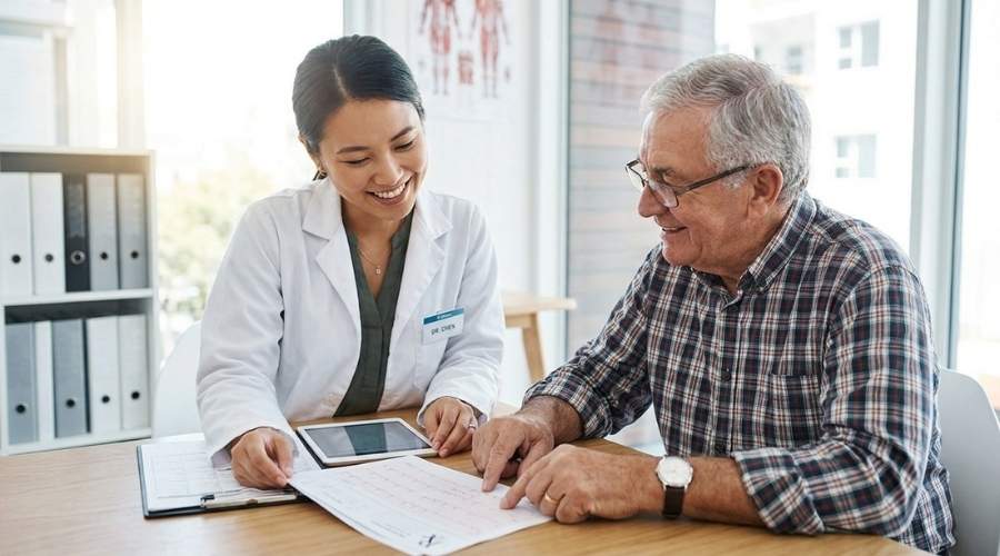 Doctor Consulting Patient on Cholesterol Medicine Consulting a doctor before choosing cholesterol support supplements or replacing medicine